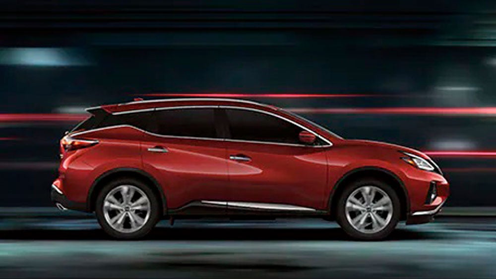 2023 Nissan Murano shown in profile driving down a street at night illustrating performance. | Briggs Nissan in Manhattan KS